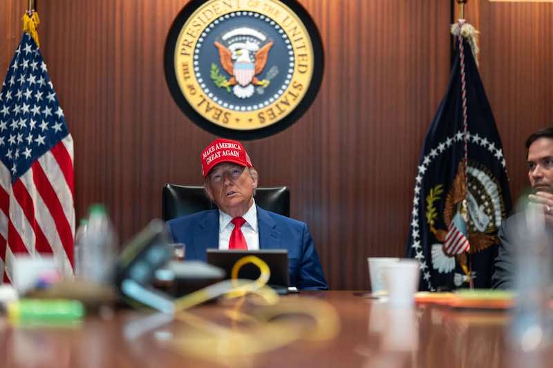 Президент Трамп в красной кепке в кабинете