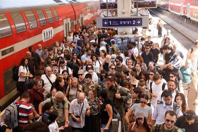 Пассажиры на железнодорожной платформе в Тель-Авиве.