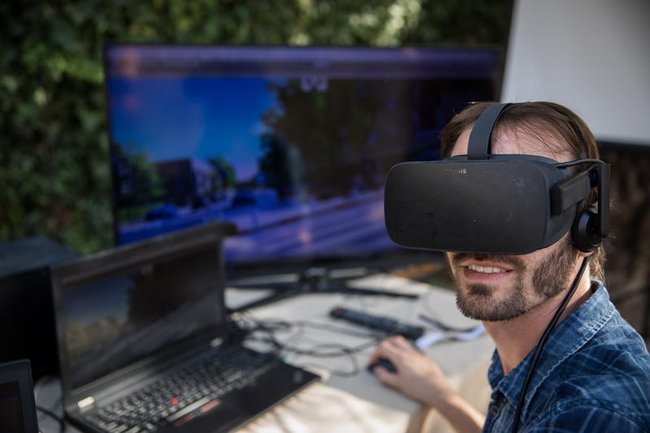 Мужчина у компьютера в VR-очках